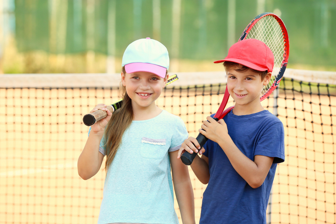 Little Children Playing Tennis on Court